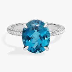 This vibrant london blue topaz gemstone makes a bold statement in this ring. Accented with two rows of round pave diamonds and set in 14k white gold, this is a stunning piece. London Blue, London Blue Topaz, Topaz Gemstone, Blue Topaz Ring, Topaz Ring, Jewelry Bags, Pave Diamonds, Semi Precious Gemstones, Blue Topaz