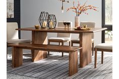 a dining room table with two chairs and a bench