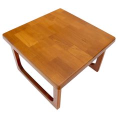 a small wooden table sitting on top of a white floor