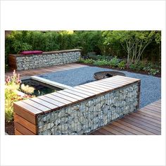 a stone bench sitting on top of a wooden deck