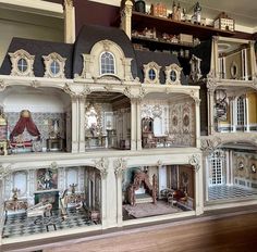 a large doll house with many rooms and furniture