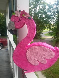 a pink flamingo decoration on the front porch