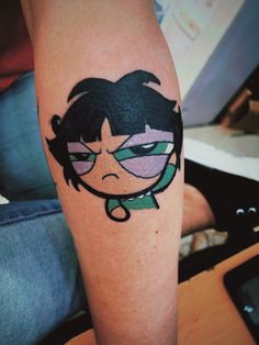 a person with a cartoon tattoo on their leg