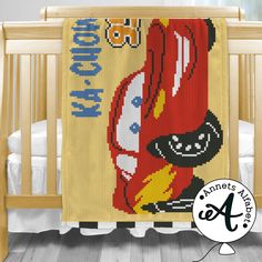 a baby crib with a red car on it and the name disney pixama