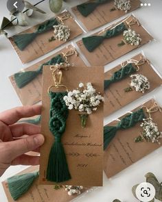 several cards with flowers and tassels attached to them