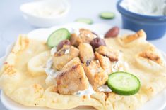 chicken and cucumber on pita bread with yogurt, olives and sour cream