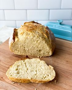 a loaf of bread sitting on top of a wooden cutting board