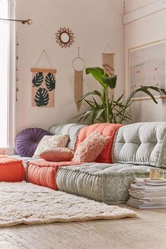 a living room filled with lots of furniture and plants