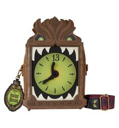 an ornate wooden clock with a keychain attached to it