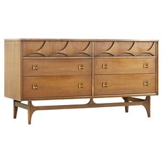 a large wooden dresser with brass handles and drawers on one side, against a white background