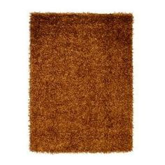 a brown rug on a white background with no one in the room to see it