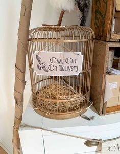 a bird in a cage with a sign on it