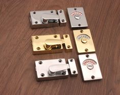 four different types of door latches on a wooden surface