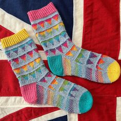 two pairs of socks sitting on top of a union jack flag