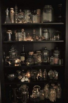 the shelves are filled with many different types of jars and pans, including glassware