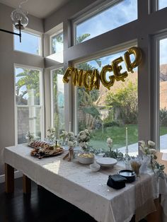 an image of a table with food and balloons in the shape of letters on it