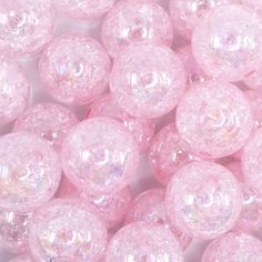 some pink gummy balls on a white surface