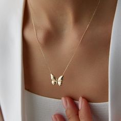 14K Solid Gold Butterfly Necklace | Minimal Dainty Necklace Delight in the elegance and simplicity of our 14K Solid Gold Butterfly Necklace. This minimal, dainty piece is designed to bring a touch of delicate beauty to your everyday look. Butterflies are rich in symbolism across various cultures and contexts. Here are some common meanings associated with butterflies: Transformation and Change: Butterflies undergo a complete metamorphosis from caterpillar to butterfly, symbolizing profound transf Dainty 14k Stamped Necklace, Feminine 14k Yellow Gold Jewelry, Elegant Everyday Necklaces Stamped 14k, Elegant Everyday 14k Stamped Necklaces, Feminine Yellow Gold Necklace For Anniversary, Lifecycle Of A Butterfly, From Caterpillar To Butterfly, Caterpillar To Butterfly, Gold Butterfly Necklace