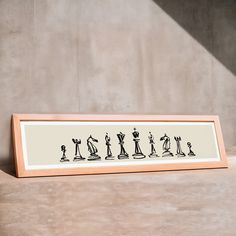 a framed art piece with chess pieces on it