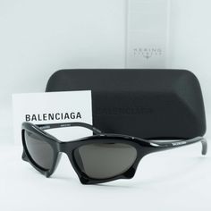 Step up your fashion game with these sleek and stylish Balenciaga BB0229S 001 Black/Grey sunglasses. Crafted by the renowned luxury brand Balenciaga, these shades exude sophistication and elegance, making them the perfect accessory for any modern man. The frame of these sunglasses is a classic black acetate, giving them a timeless and versatile look that can easily be dressed up or down. The black color of the frame adds a sense of mystery and edginess to the overall aesthetic, making them a per Yeezy Gap Glasses, Luxury Men's Gray Sunglasses, Yeezy Gap Sunglasses, Luxury Modern Gray Sunglasses, Luxury Sleek Acetate Sunglasses, Kylie Jenner Model, Kylie Jenner Modeling, Balenciaga Sunglasses, Balenciaga Leather