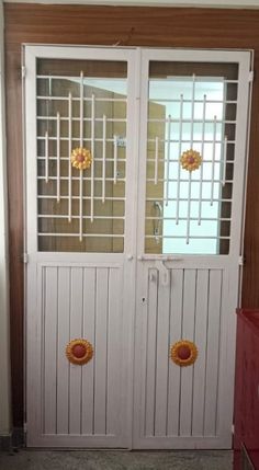 two white doors with decorative glass on them