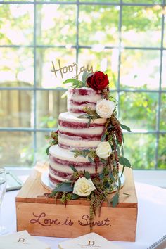 a wedding cake sitting on top of a wooden box