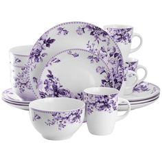 a purple and white dinnerware set with flowers on the front, two cups and one saucer