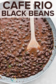 a pan filled with black beans on top of a table