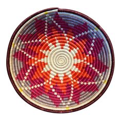 a red and white basket with an orange center in the middle on a white background