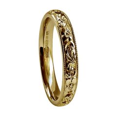 a gold wedding ring with filigrees on it