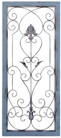 an ornate iron door with blue painted frame