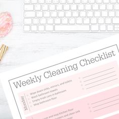 a pink cleaning checklist sitting on top of a white desk next to a keyboard