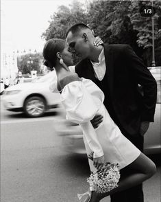 a man and woman kissing on the street