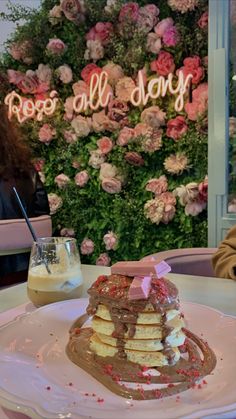 a stack of pancakes sitting on top of a white plate