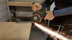 a person grinding metal with a grinder