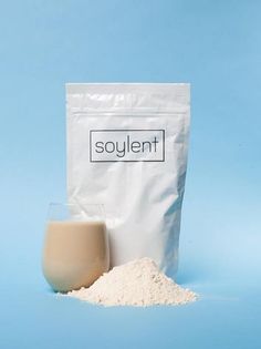 a bag of soy next to a glass of milk on a blue background with the word soy