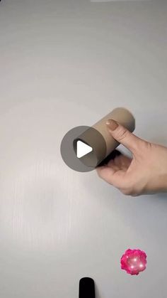 a person is holding a roll of toilet paper