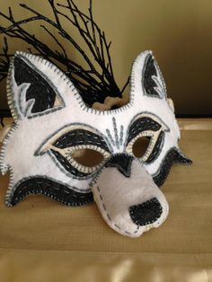 a white and black mask sitting on top of a table