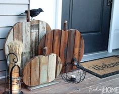 a couple of pumpkins sitting on top of a wooden stand next to a door