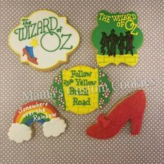 four decorated cookies with the wizard of oz and rainbows on them, all in different colors