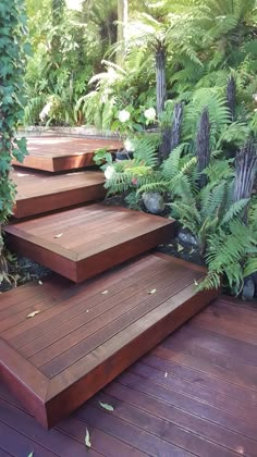 the steps are made out of wood and surrounded by greenery