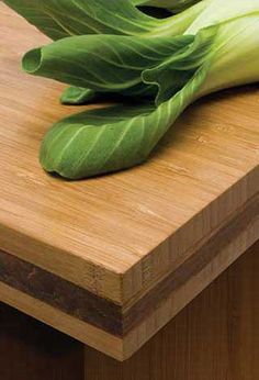 green leafy vegetables are sitting on a cutting board