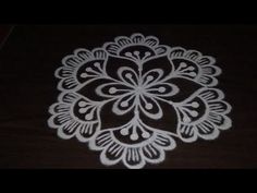 a white doily on top of a wooden table