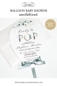 an elegant baby shower is displayed on the front of a white envelope with silver ribbon