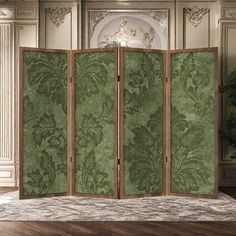 an ornate room divider in green and white