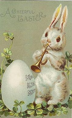 an easter card with a rabbit playing the trumpet and egg in it's mouth