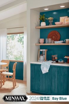 a kitchen with teal cabinets and white counter tops is featured in the magazine miniwax