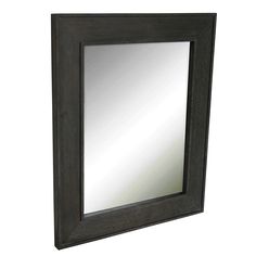 a black framed mirror on a white wall