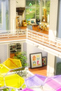 the inside of a house with many different colored umbrellas in front of it,