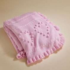 a pink blanket laying on top of a table